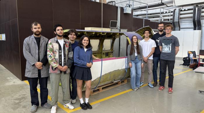group of students in front of an airplane